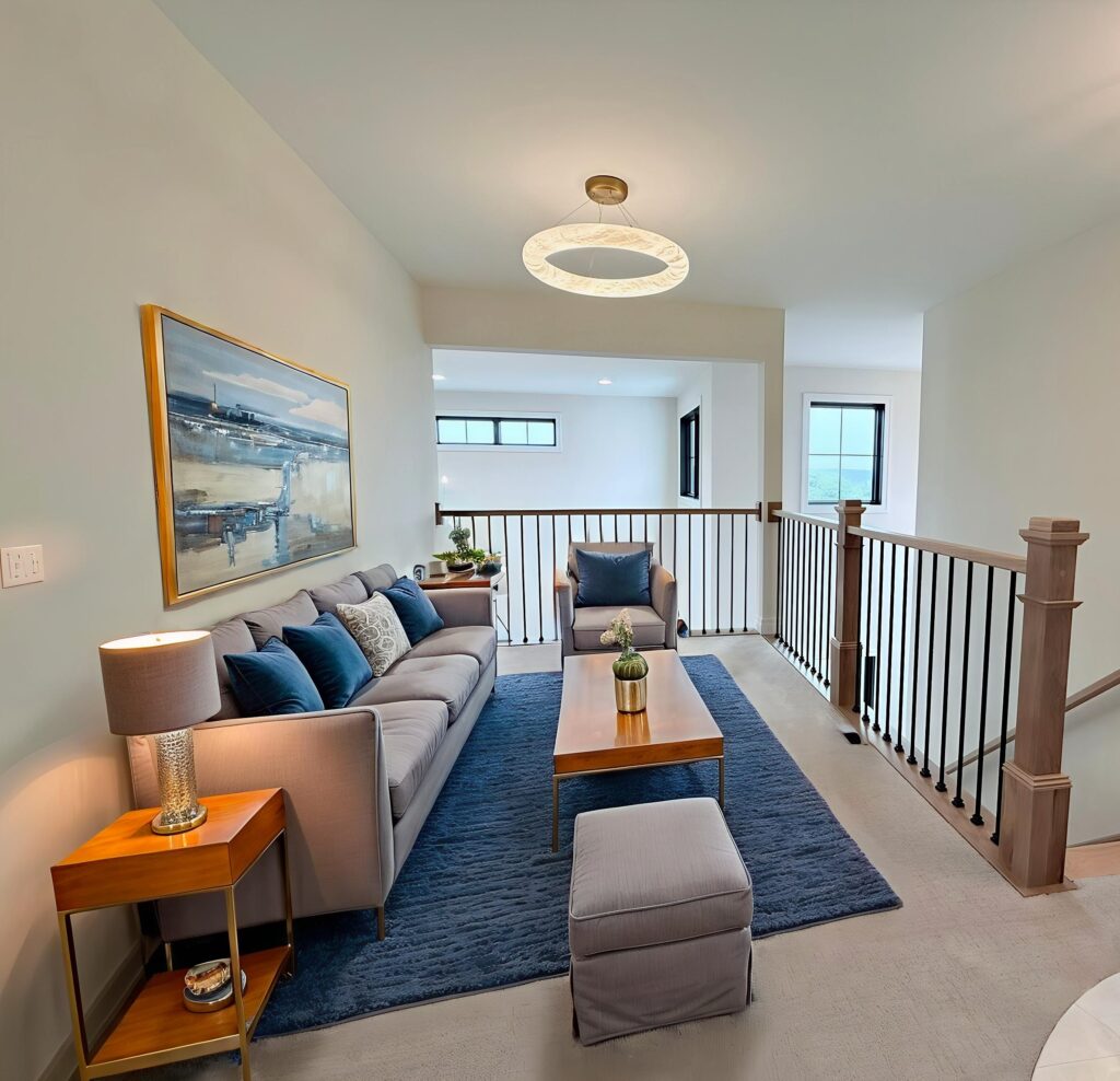 Stunning-Upstairs-Gathering-Area-in-Blue-White-with-Modern-Light-Fixture