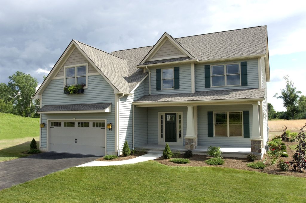 The Morris 2-Story Home with Light Blue-Gray Siding, Dark Shutters, Covered Front Porch with Stone Accents & 2-Car Garage