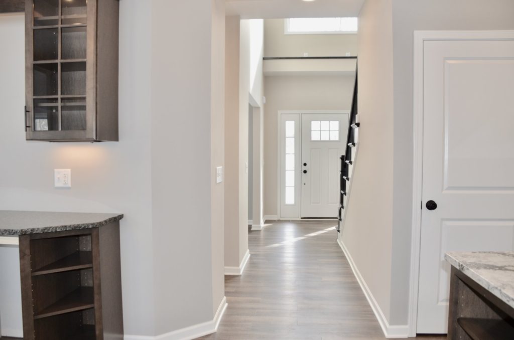 Bradford-Kitchen-Hall-View-with-Built-In-Cabinetry-Wood-Look-Flooring-and-Front-Entry-Sightline