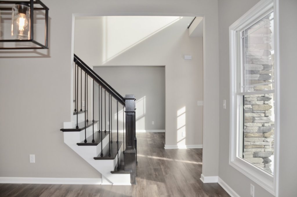 Bradford-Dining-Area-with-Picture-Window-Staircase-View-and-Wood-Look-Flooring
