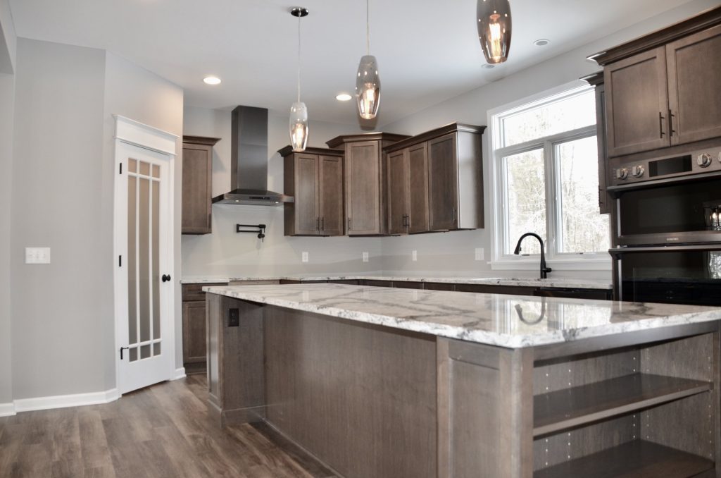 Bradford-Kitchen-with-Dark-Cabinetry-Quartz-Counters-Stainless-Hood-and-Large-Center-Island