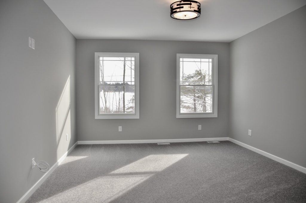 Bradford-Secondary-Bedroom-with-Gray-Carpet-Double-Windows-and-Neutral-Walls