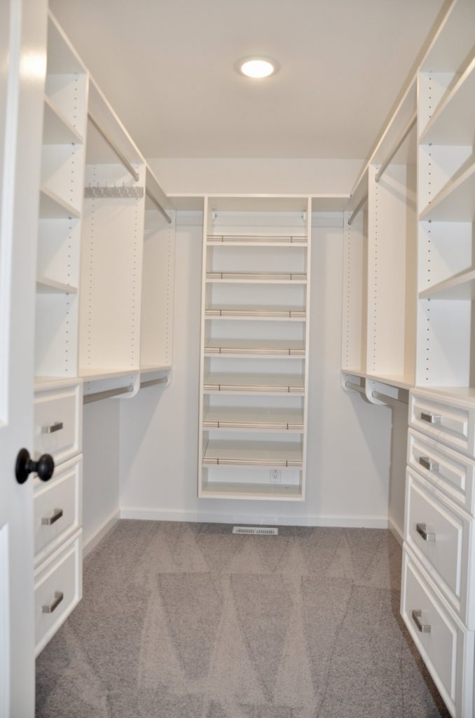 Bradford-Walk-In-Closet-with-Built-In-Shelving-Drawer-Storage-and-Gray-Carpet