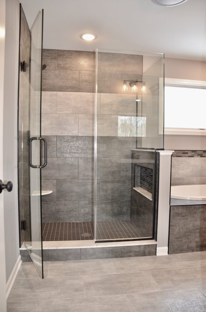 Bradford-Glass-Enclosed-Shower-with-Large-Format-Gray-Tile-Built-In-Bench-and-Black-Hardware