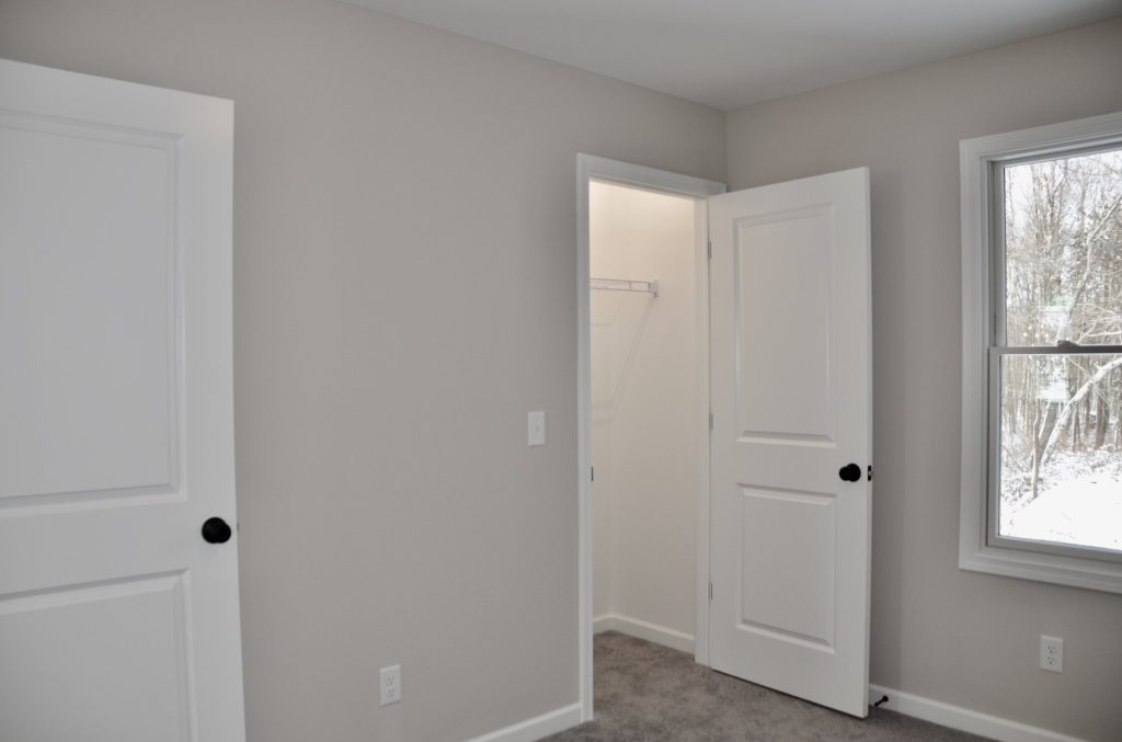 Bradford-Secondary-Bedroom-with-Gray-Carpet-Open-Closet-Door-and-Tall-Window