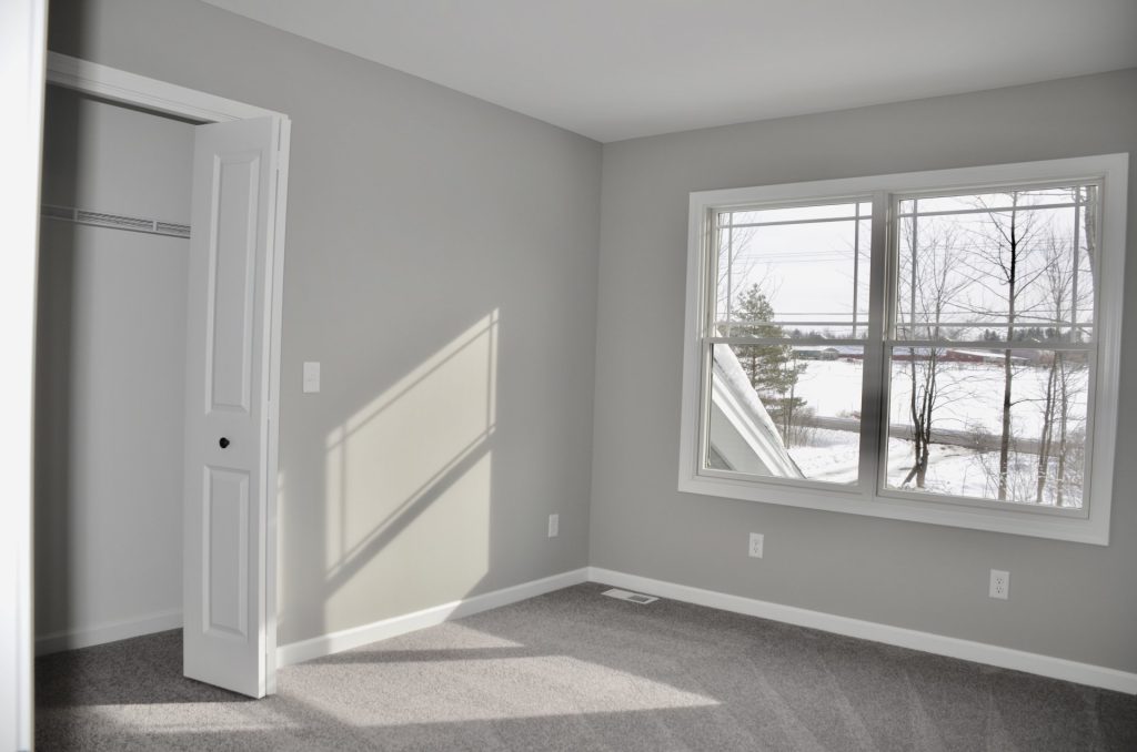Bradford-Secondary-Bedroom-with-Gray-Carpet-Large-Window-and-Closet-Entry
