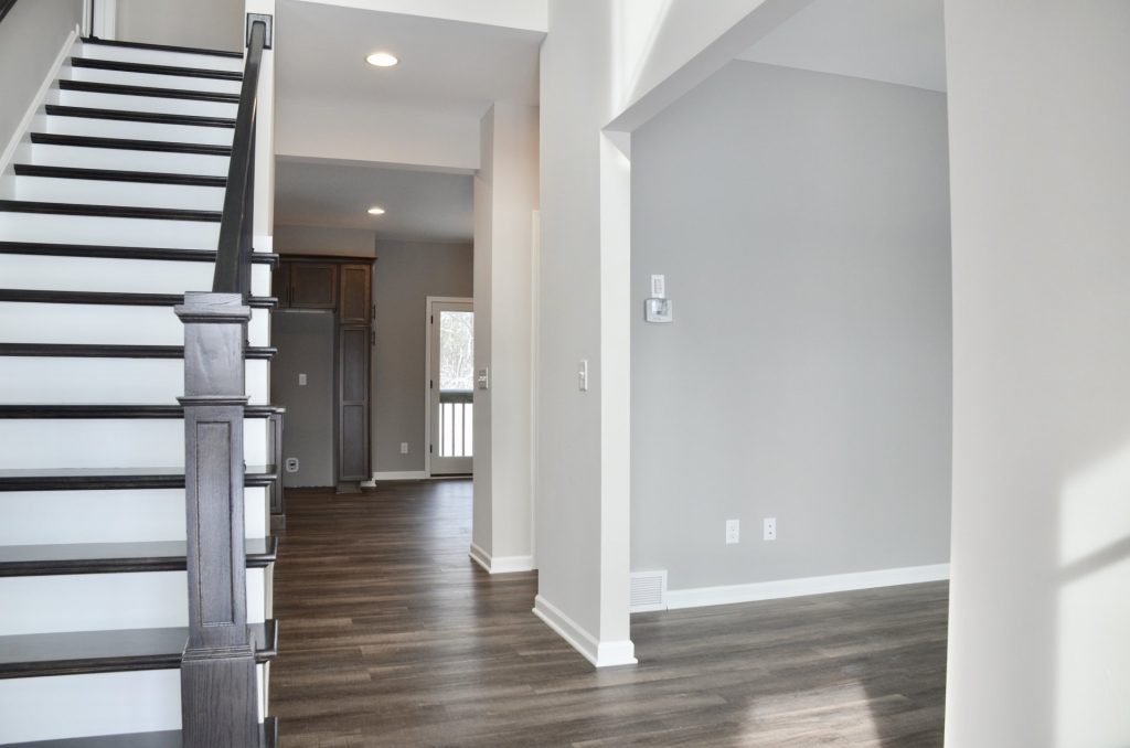 Bradford-Foyer-and-Front-Flex-Room-Entry-with-Dark-Wood-Staircase-Gray-Walls-and-Wood-Look-Flooring