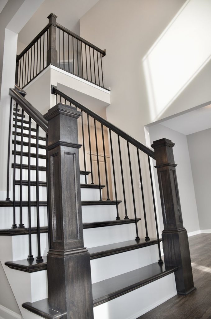 Bradford-Staircase-with-Dark-Wood-Newel-Posts-Black-Balusters-and-Open-Loft-View