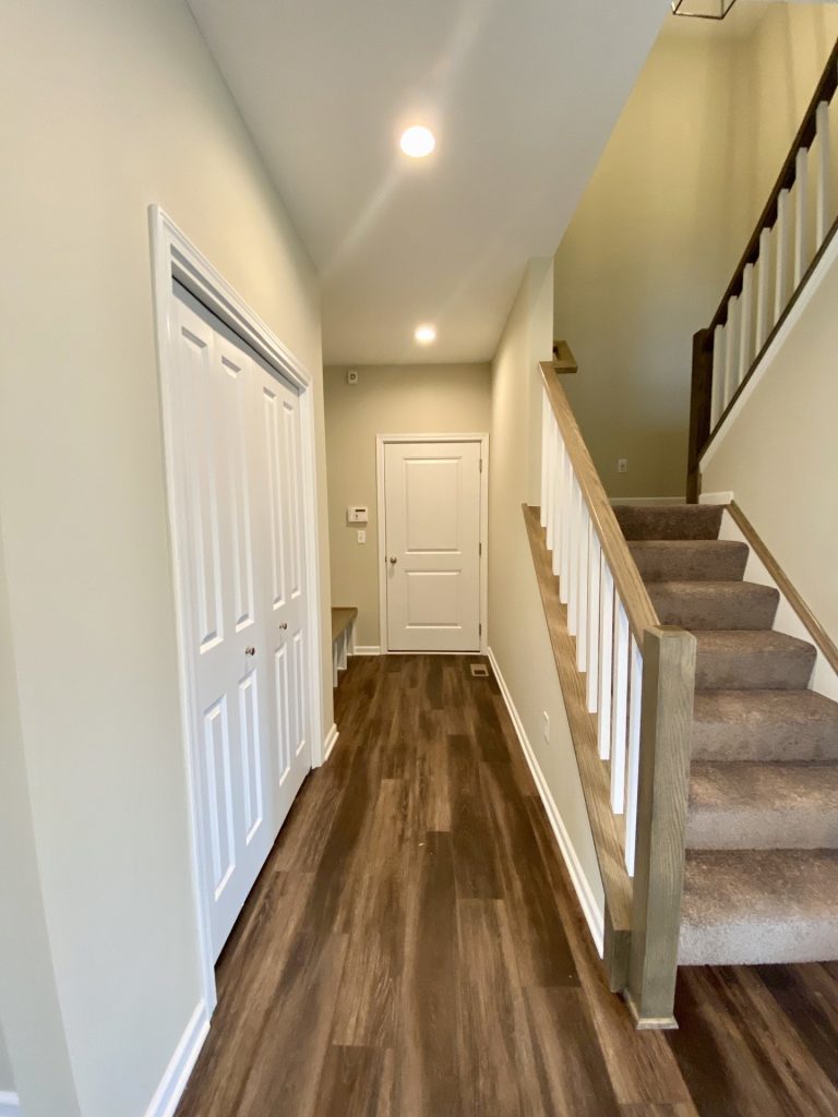 Concord-I-Mudroom-Hall-with-Bench-Closet-Doors-Staircase-and-Dark-Wood-Look-Flooring
