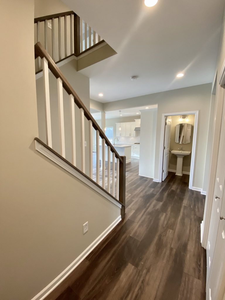 Concord-I-Interior-Hallway-with-Staircase-Powder-Room-View-and-Kitchen-Access
