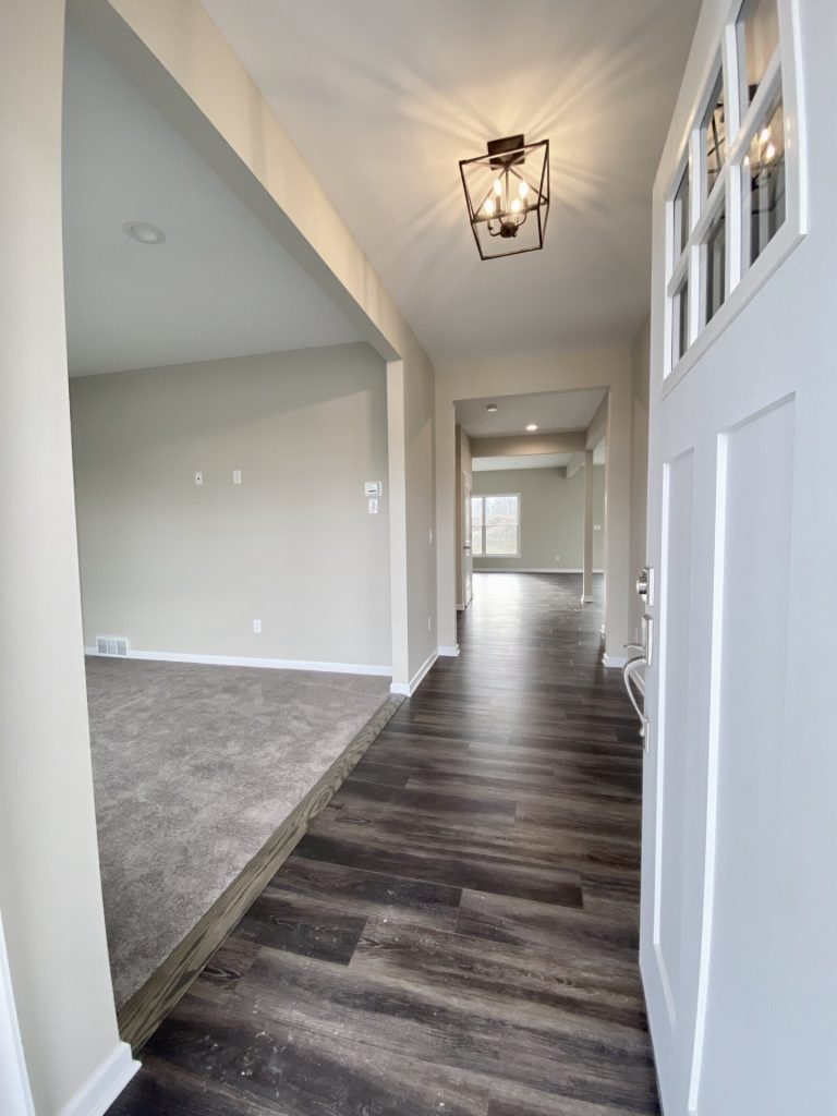 Concord-I-Front-Entry-Hall-with-Dark-Wood-Look-Flooring-White-Front-Door-and-Front-Flex-Room-View