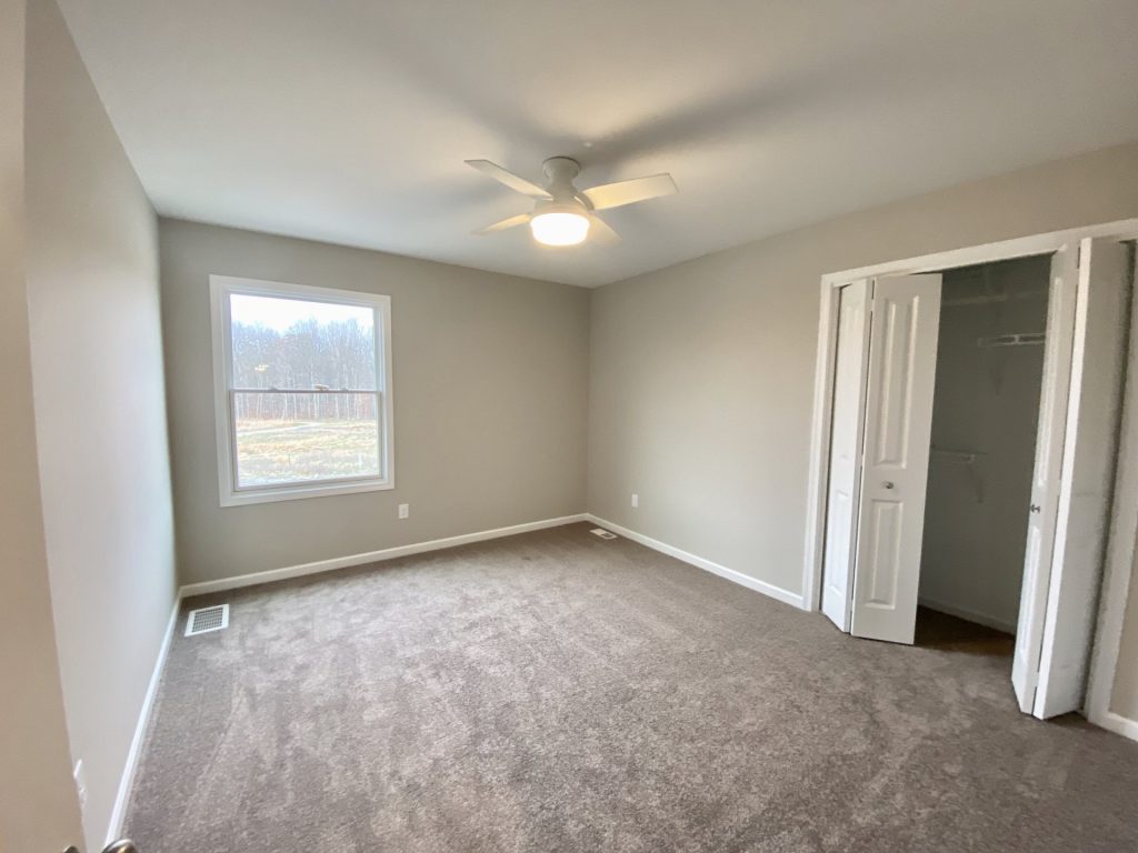 Concord-I-Secondary-Bedroom-with-Neutral-Carpet-White-Ceiling-Fan-and-Open-Closet