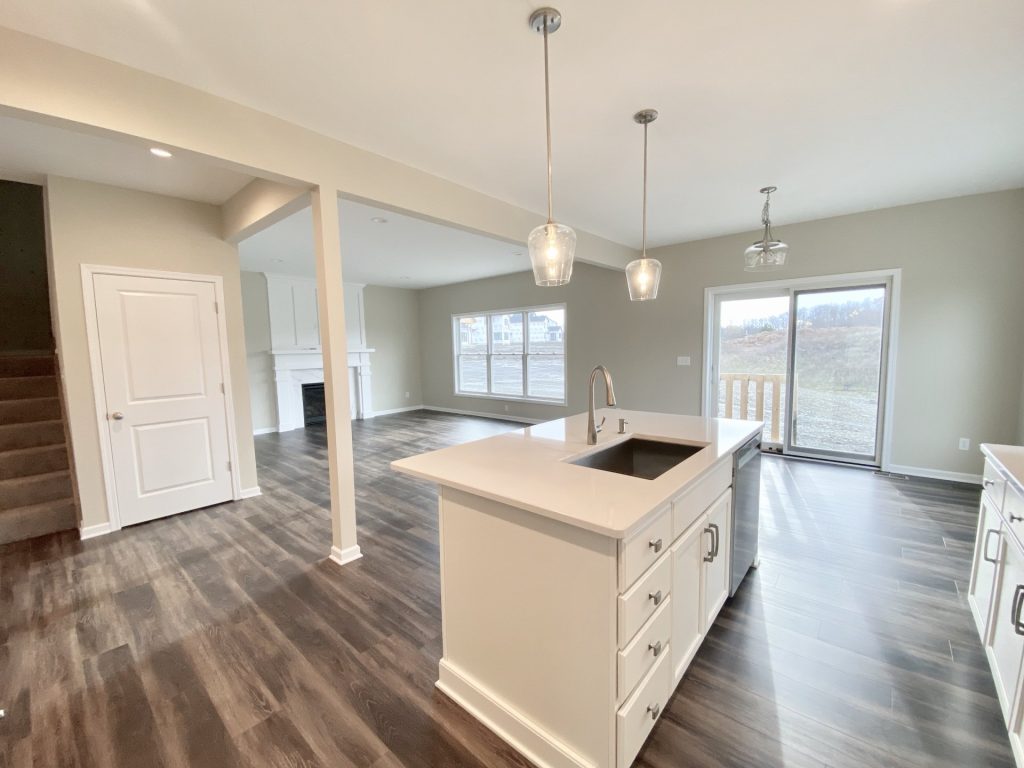 Concord-I-Kitchen-Island-View-with-Pendant-Lights-Sliding-Glass-Door-and-Great-Room-Fireplace
