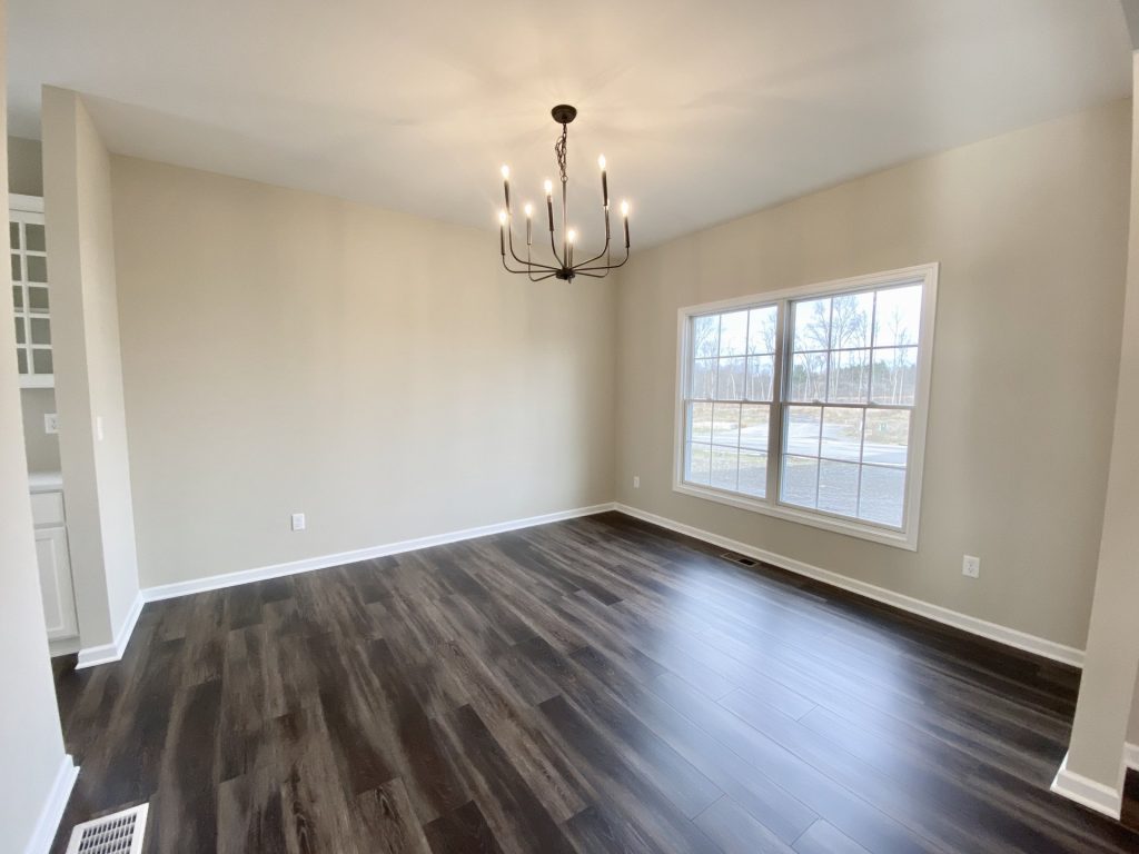 Concord-I-Dining-Room-with-Dark-Wood-Look-Flooring-Modern-Chandelier-and-Double-Window