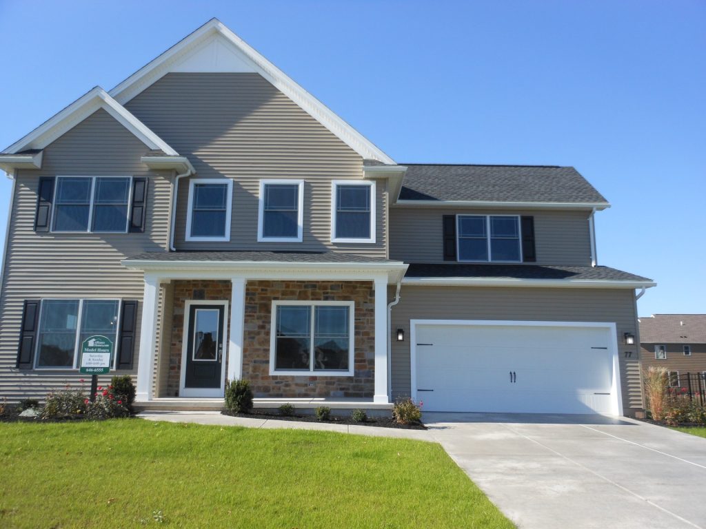 2-Story Home Exterior with Taupe Siding & Brick with 2-Car Garage