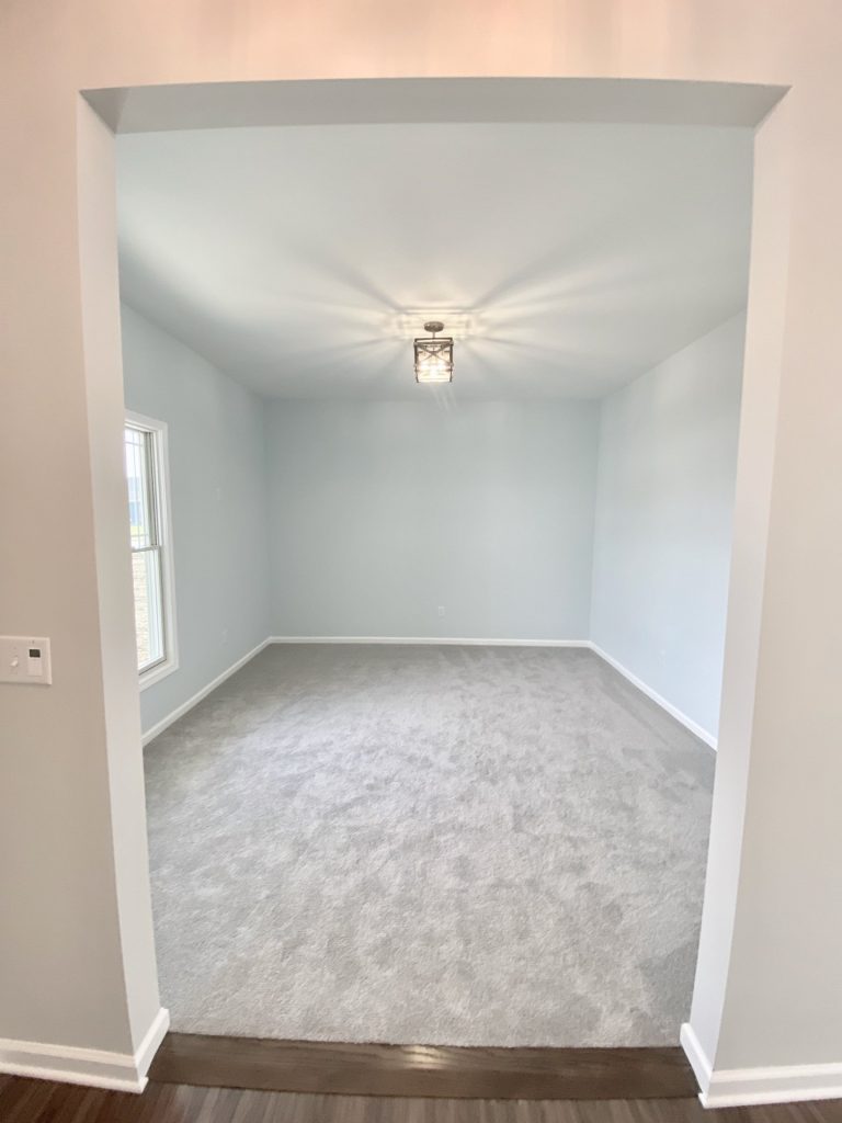 The Forsythe Front Den with Light Carpet, Soft Gray Walls, White Trim & Front Window