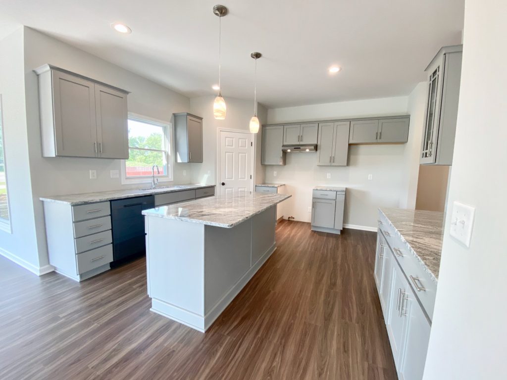 The Forsythe Kitchen with Gray Island, Pendant Lights, Quartz Counters, Gray Cabinetry & Wood-Look Flooring