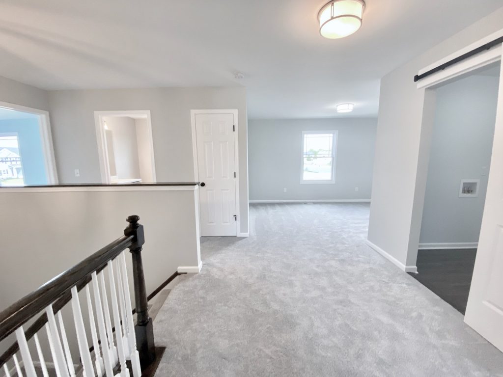 The Forsythe Upstairs Hallway at Top of Stairs to Bedroom with Light Gray Carpet