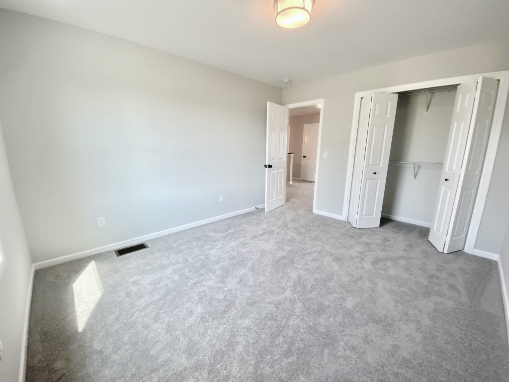 The Forsythe Bedroom with Open Closet, Hall Entry, Light Carpet & Neutral Walls