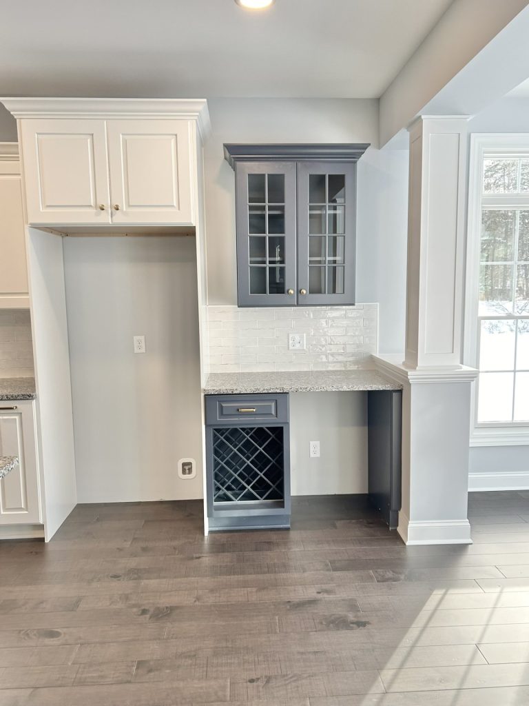 The Maple with Loft Kitchen with Refrigerator Nook, Glass Cabinet Doors, Wine Storage, Quartz Countertop & Wood-Look Flooring