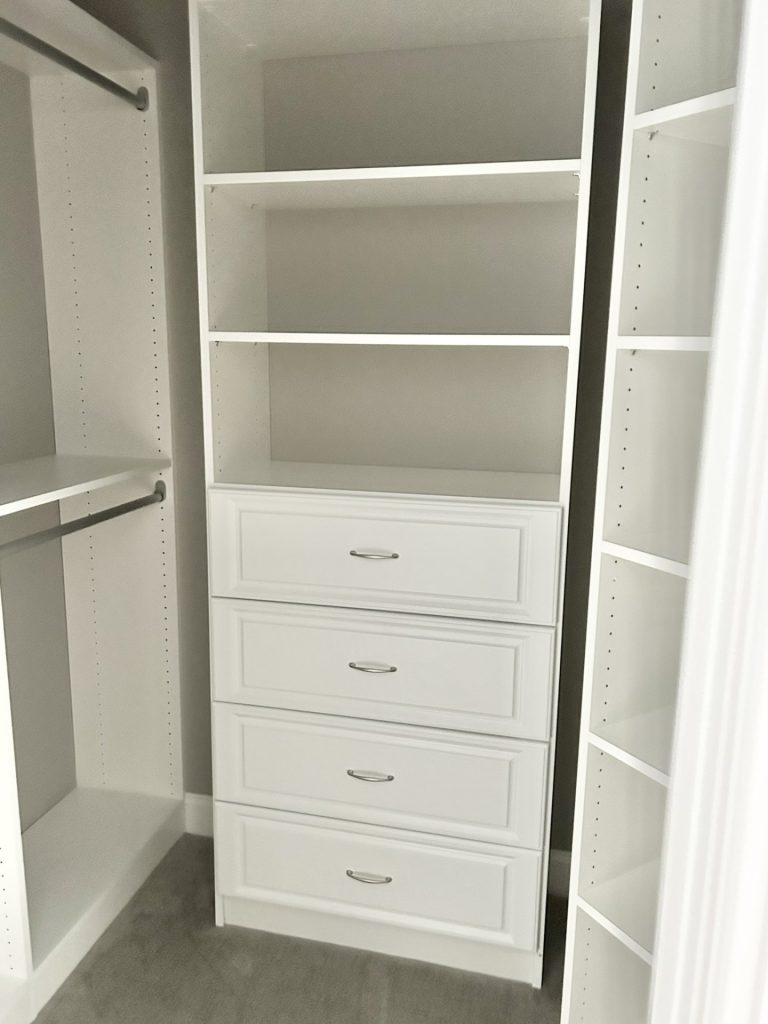 The Maple with Loft Walk-In Closet with Built-In Drawers, Open Shelving, Neutral Carpet & White Storage System