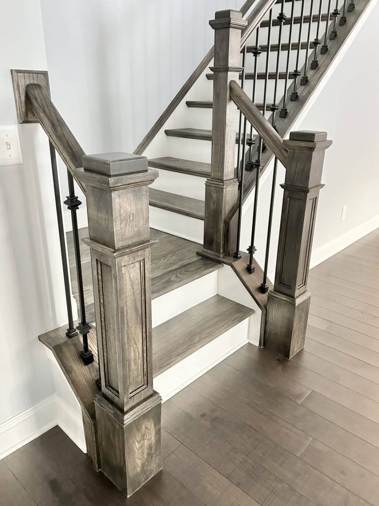 he Maple with Loft Staircase Detail with Wood Newel Posts, Wood Treads, Black Balusters & Wood-Look Flooring