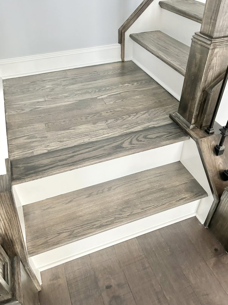The Maple with Loft Stair Tread Detail with Wood Grain Finish, White Risers & Neutral Walls