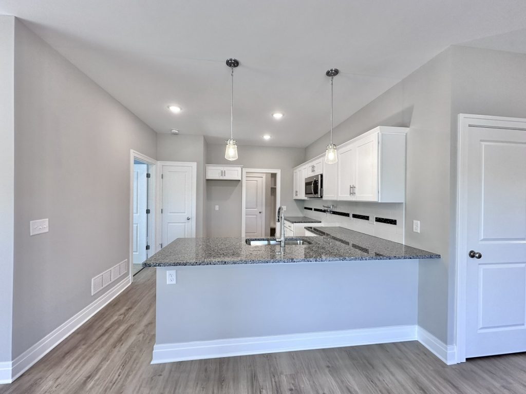 Pretty-Corner-Kitchen-with-Marble-Countertops-in-White-and-Neutrals