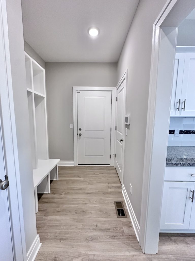 Home-Entry-Way-in-White-Neutrals-with-Foyer-Bench-Shelving