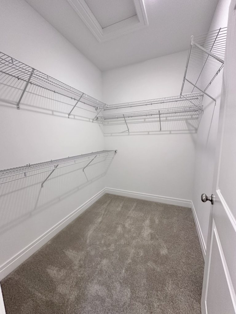 White-Walk-in-Closet-with-Carpet-Built-in-Shelving