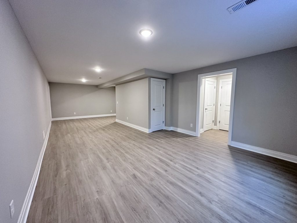 Finished-Lower-Level-with-Recessed-Lighting-Closets-and-Storage