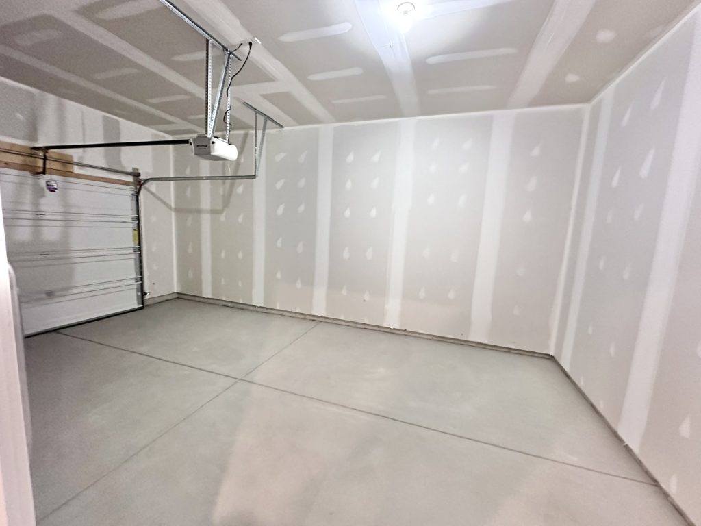 Madison-Attached-Garage-with-Drywalled-Walls-Concrete-Floor-and-Automatic-Door-Opener