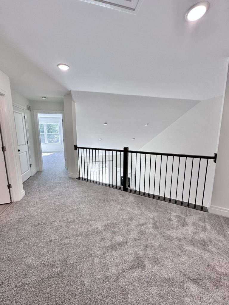 Madison-Loft-Overlook-with-Gray-Carpet-Black-Railing-and-Open-View-to-Great-Room