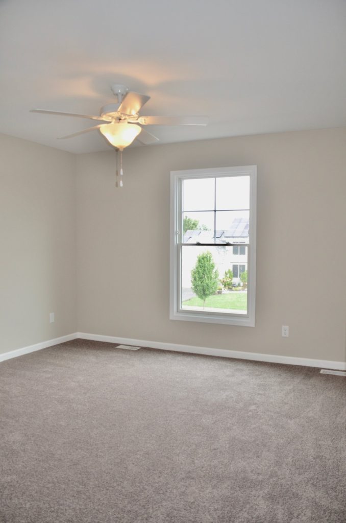 The Griffon Bedroom with Light Carpet, Single Window, Neutral Walls & Ceiling Fan