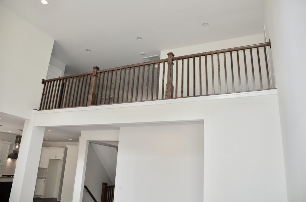 Arbordale-Loft-Overlook-with-Dark-Wood-Railing-White-Walls-and-Open-View-Below