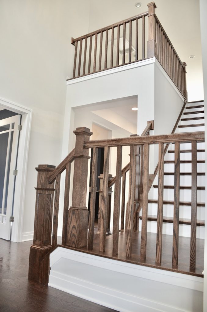 Arbordale-Two-Story-Foyer-Staircase-with-Dark-Wood-Railings-White-Trim-and-Loft-Overlook
