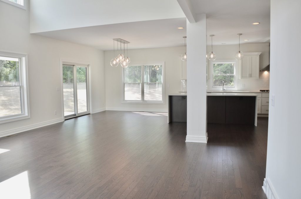 Arbordale-Open-Dinette-and-Kitchen-with-Sliding-Glass-Door-Large-Windows-and-Waterfall-Island