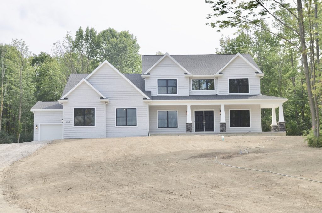 Arbordale-2-Story-Craftsman-Style-Home-with-Light-Siding-Covered-Front-Porch-Upper-Level-and-Garage