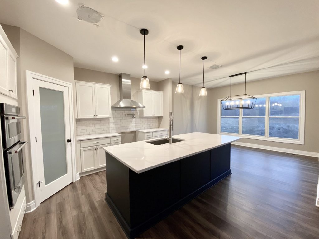 The Portsmouth Kitchen and Dinette with Large Island, Picture Window, Pendant Lights and White Cabinetry