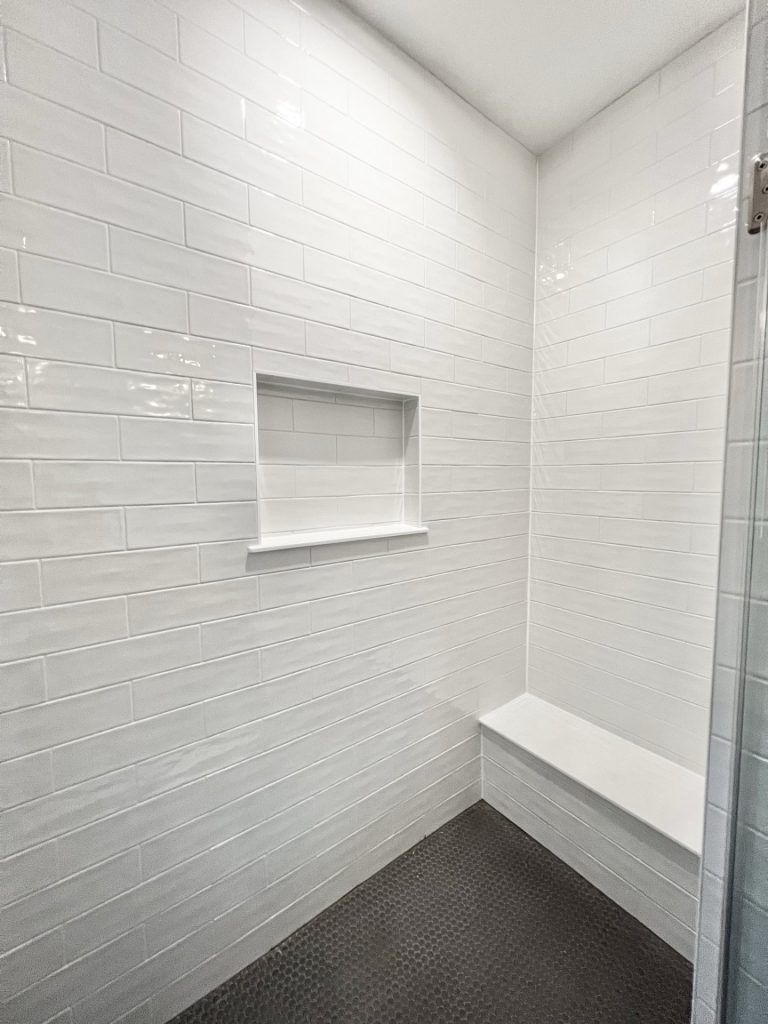 The Cedar Walk-In Shower with White Tile Walls, Bench Seat, Built-In Niche & Penny Tile Floor