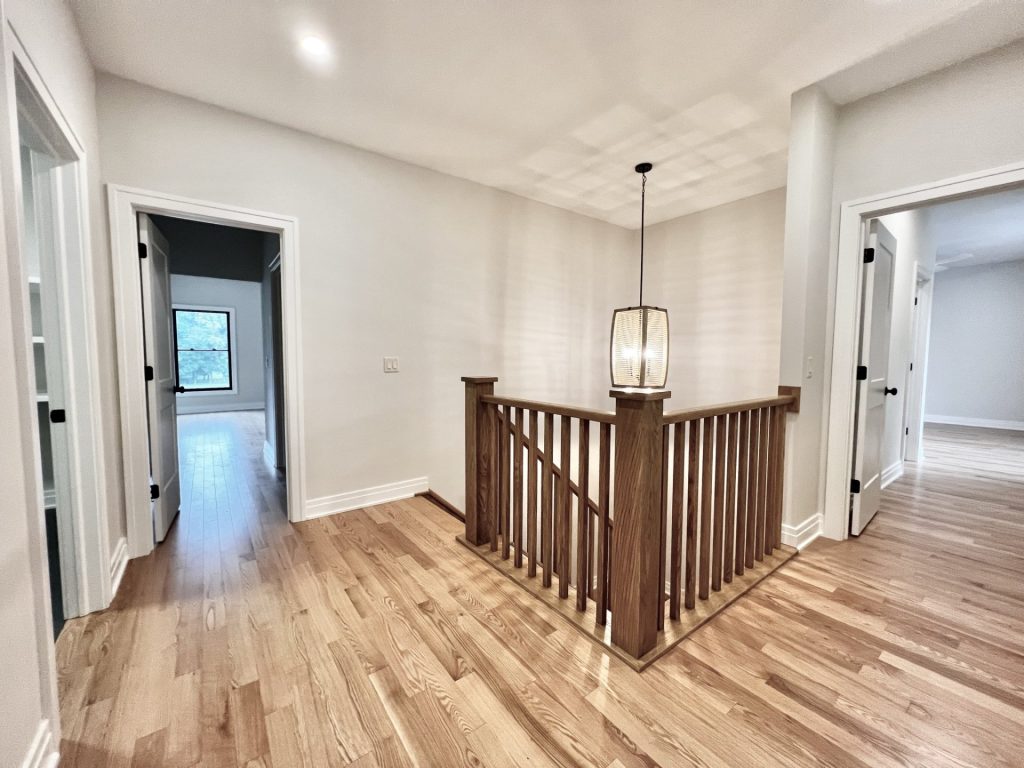The Cedar Upper Landing with Wood Flooring, Open Railing, Pendant Light & Bedroom Hallways