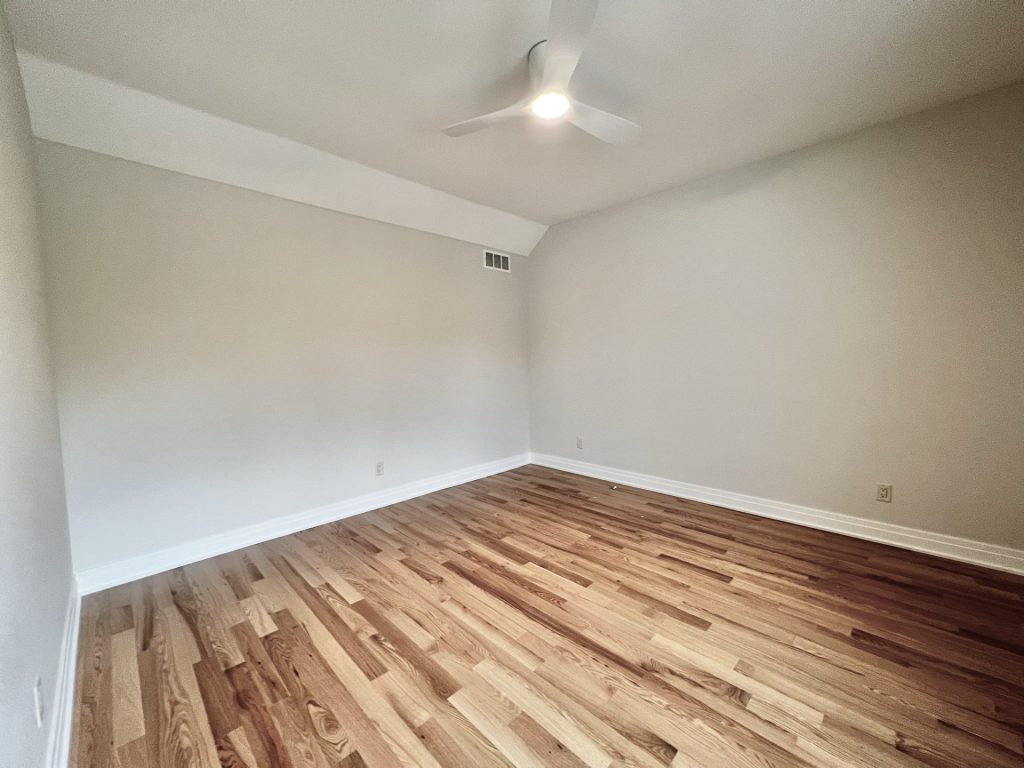 The Cedar Bedroom with Hardwood Flooring, Ceiling Fan, Neutral Walls & Spacious Layout