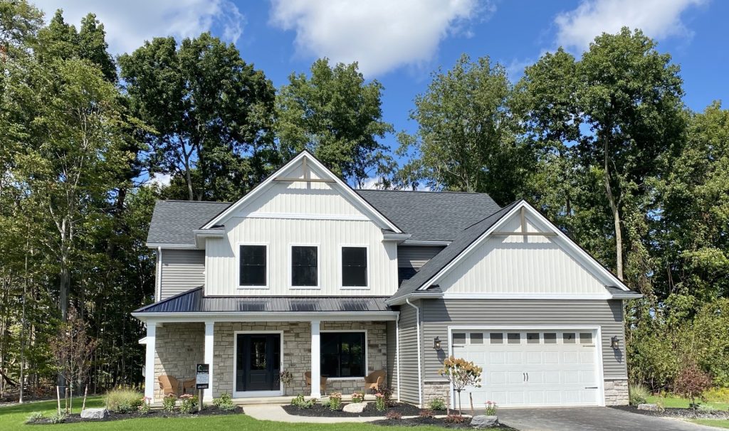 The Ruskin 2.0 2-Story Model Home with Gray Siding, White Board-and-Batten Gables, Stone Accents, Covered Front Porch & 2-Car Garage