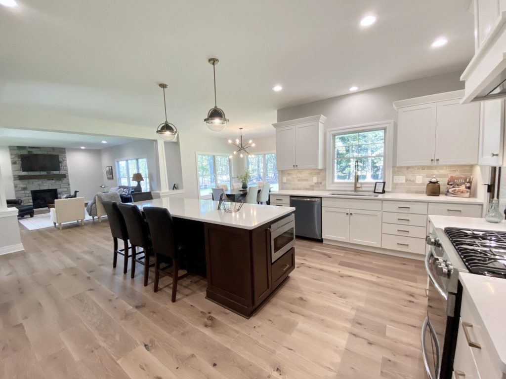 The Ruskin 2.0 Oversized Kitchen Island, Sink Wall with White Cabinetry, Window, Quartz Counters & Tile Backsplash