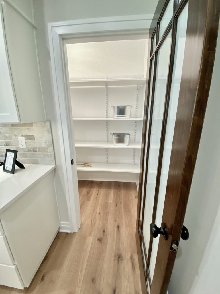 The Ruskin 2.0 Walk-In Pantry Entry with Frosted Glass Door, Open Shelving & Wood-Look Flooring