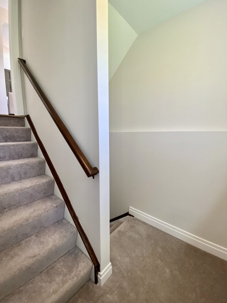 The Ruskin 2.0 Stair Landing Niche with Half Wall, Carpeted Steps & Neutral Walls