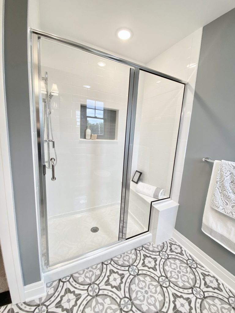 The Weston Walk-In Shower with Glass Enclosure, White Tile Walls, Patterned Tile Floor & Built-In Niche