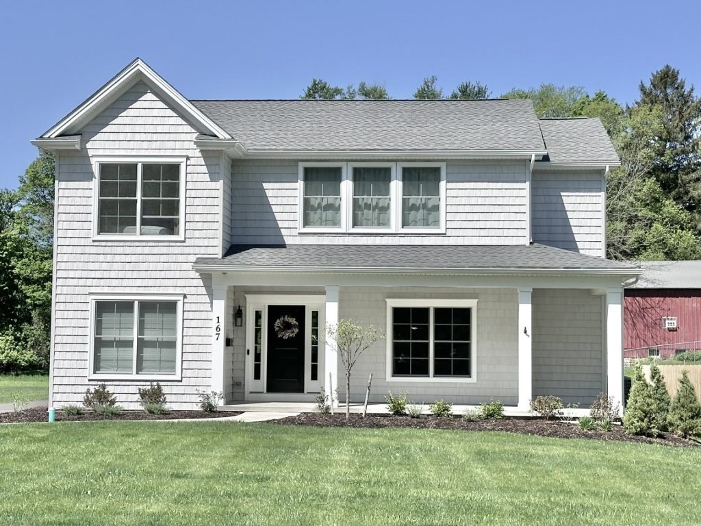 The Willow 2-Story Home Exterior with Light Gray Siding, White Trim and Covered Front Porch with Black Front Door