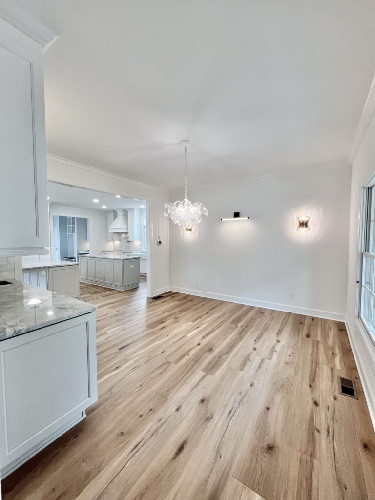 The Willow Kitchen Dining Area with Bubble Chandelier, Accent Sconces, Neutral Walls & Wood-Look Flooring
