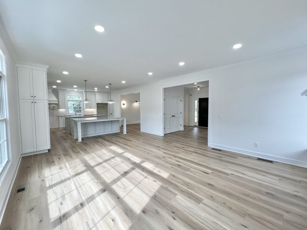 The Willow Open Great Room and Kitchen with Large Window, Oversized Island, Double Doors & Wood-Look Flooring